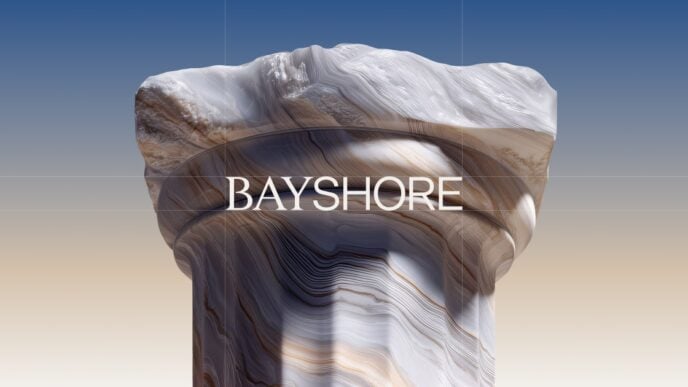 Rock column with layered, swirled patterns against a gradient sky, bearing the BAYSHORE text across the middle.