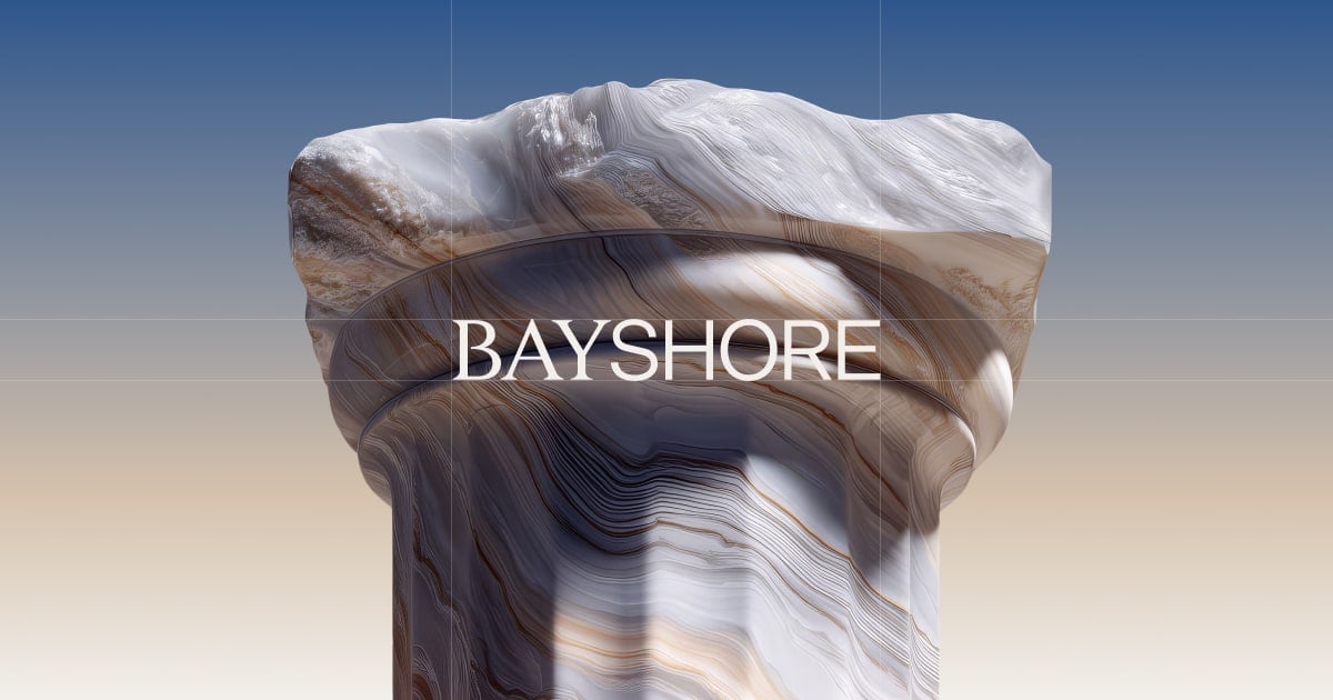 Rock column with layered, swirled patterns against a gradient sky, bearing the BAYSHORE text across the middle.